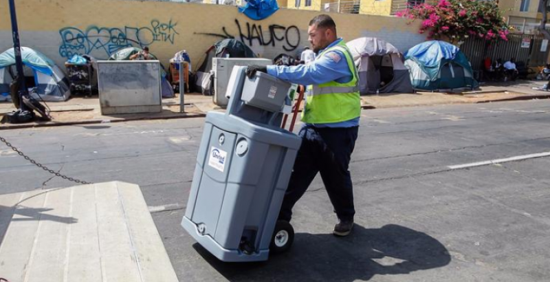 United Site Services worker moving a hand washing station