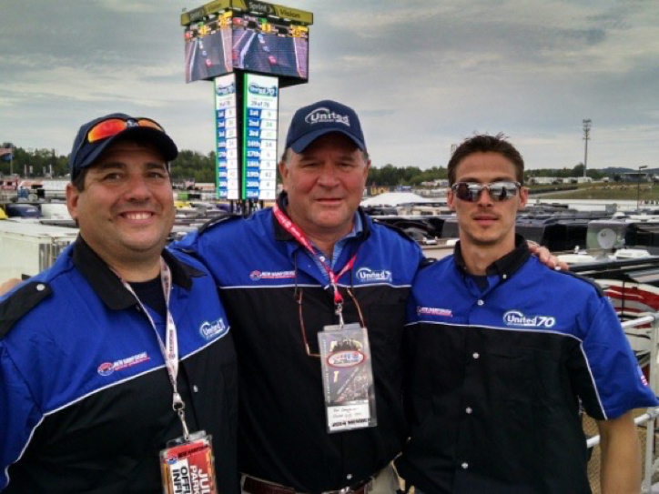 3 men posing for a photo at a nascar race