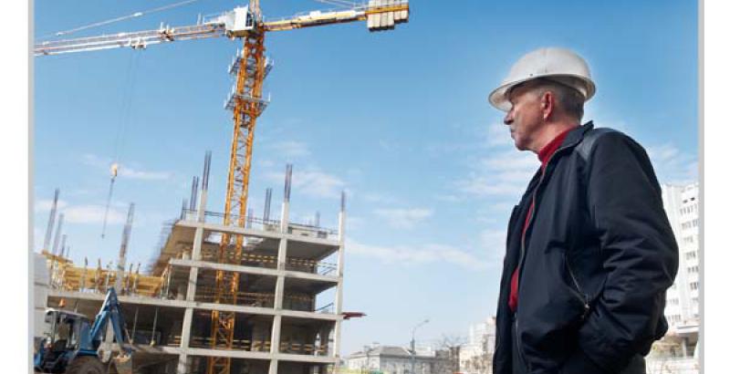 a construction worked looking at the building in progress