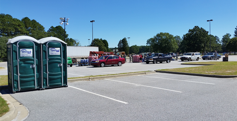 two emergency porta potties for flooding in a parking lot