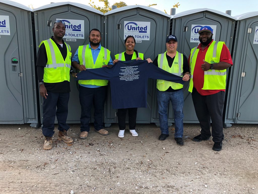 5 united site services employees standing in front of porta potties