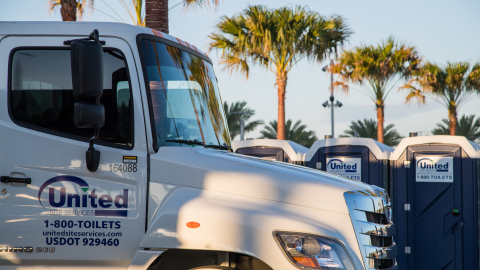 united site services truck in the foreground with several porta potties in the background