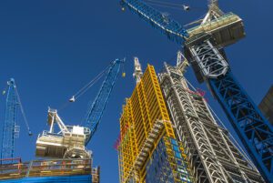 two construction cranes building a skyscrapper